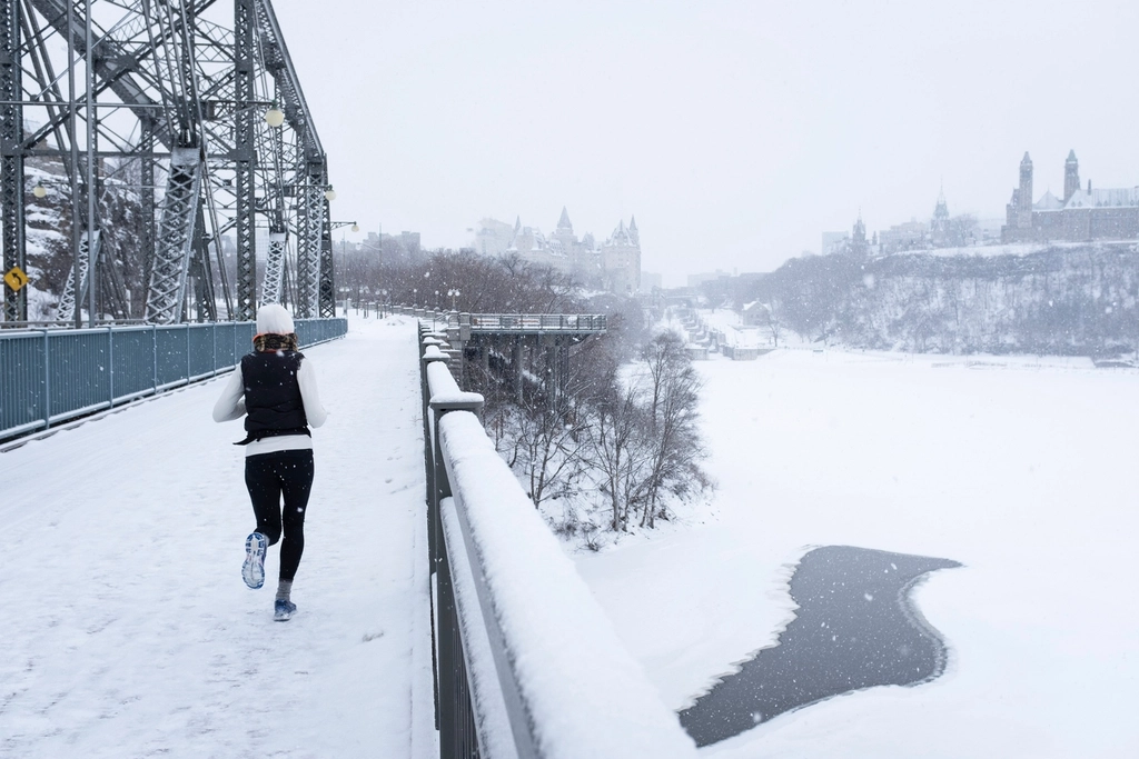 A runner on a city street at dawn